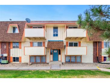 Two-story apartment building featuring multiple balconies and a well-maintained lawn at 10211 Ura Ln # 2-207, Thornton, CO 80260