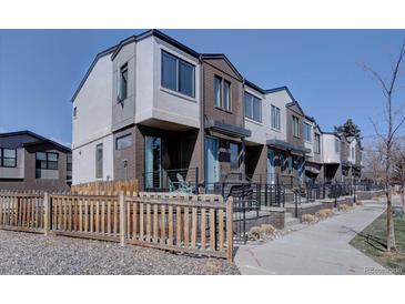 Modern townhomes showcase a mix of brick and siding with individual front patios and well-maintained landscaping at 5469 S Curtice St # L, Littleton, CO 80120