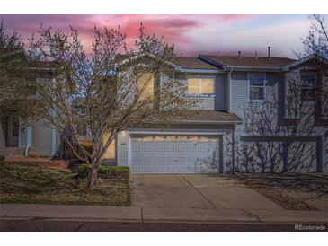 Charming two-story townhome with attached two-car garage and mature landscaping at 2415 E 110Th Dr, Northglenn, CO 80233