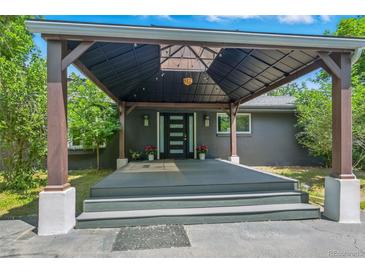 Inviting home entrance with a covered porch, sleek front door, and stylish exterior details at 6505 W Hampden Ave, Lakewood, CO 80227