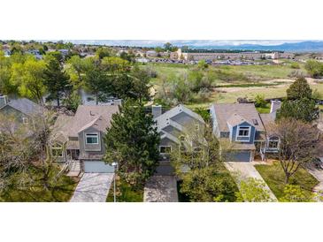 Charming townhouse featuring a well-maintained lawn, attached garages, and mature trees in a serene neighborhood at 11427 King Way, Westminster, CO 80031