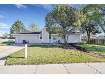 Charming single-story home with a well-maintained lawn, mature tree, and an attached two-car garage at 3561 W 131St Ave, Broomfield, CO 80020