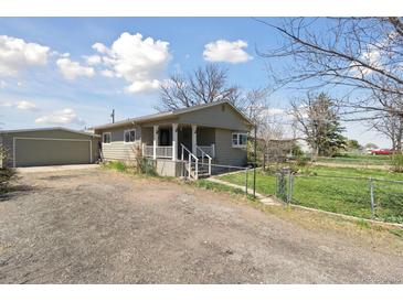 Charming single story home with a front porch and detached garage at 575 2Nd St, Bennett, CO 80102