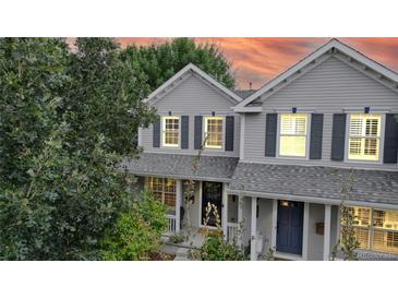 Two-story house with gray siding, navy door, and a well-manicured lawn at 2456 S Marion St, Denver, CO 80210