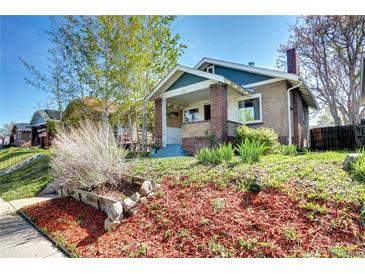 Charming brick home with landscaped front yard and mature trees, offering great curb appeal at 3336 N Saint Paul St, Denver, CO 80205