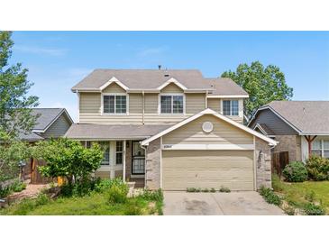 Two-story home with a two-car garage and a well-kept lawn in a suburban neighborhood at 4064 S Himalaya Way, Aurora, CO 80013