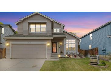 Charming two-story home with a well-manicured lawn, covered entryway, and attached two-car garage at 3305 W 126Th Ave, Broomfield, CO 80020