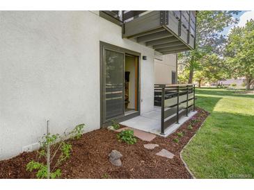 Cozy ground floor patio with wooden fence, stone pavers and mulch landscaping on a sunny day at 6505 Kalua Rd # 104B, Boulder, CO 80301