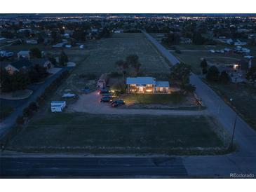 Aerial view of house, expansive lot, and surrounding area at dusk at 12626 N 1St St, Parker, CO 80134