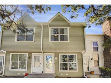 Inviting exterior of a two-story townhome with light green siding and large windows at 3253 S Estes St, Lakewood, CO 80227