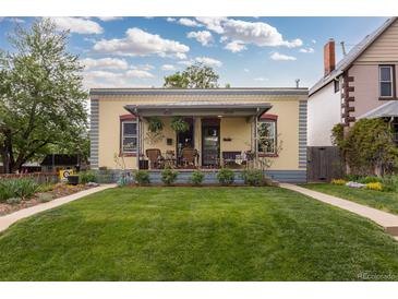 Charming home featuring a well-manicured lawn, inviting porch, and colorful facade, perfect for a cozy curb appeal at 4528 W 34Th Ave, Denver, CO 80212