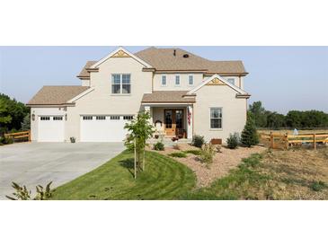 Charming two-story home boasts a well-manicured lawn, three-car garage and a welcoming front porch, perfect for relaxation at 1221 W 144Th Ct, Westminster, CO 80023