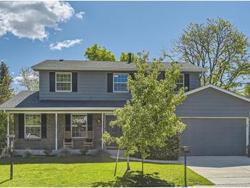 Charming two-story home with a manicured lawn and an attached two-car garage at 4196 S Reading Way, Denver, CO 80237