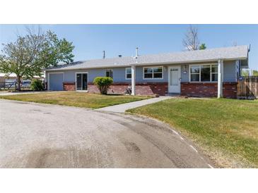 Charming single-story home with brick accents, well-maintained lawn, and a welcoming entrance at 14347 E 134Th Ave, Brighton, CO 80601