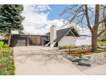 Modern home with white exterior, mature landscaping, and striking architectural details at 1884 S Ivy St, Denver, CO 80224