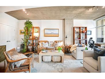 Inviting living room featuring stylish furniture, decor, and abundant natural light at 1700 Bassett St # 314, Denver, CO 80202