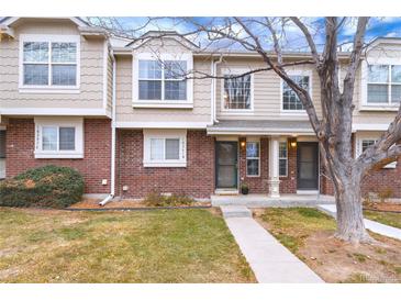 Attractive townhome with brick and siding exterior, well-maintained landscaping, and a welcoming entrance at 18397 E Alabama Pl # D, Aurora, CO 80017