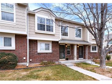 Charming two-story home featuring brick accents, well-manicured lawn, and inviting entryway at 18397 E Alabama Pl # D, Aurora, CO 80017