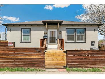 Charming front exterior featuring a secure fence and easy access to both units A and B at 2441 E 47Th Ave, Denver, CO 80216