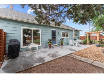 Cozy backyard patio with outdoor dining area, perfect for entertaining and enjoying outdoor living at 247 Tipple Pkwy, Frederick, CO 80530