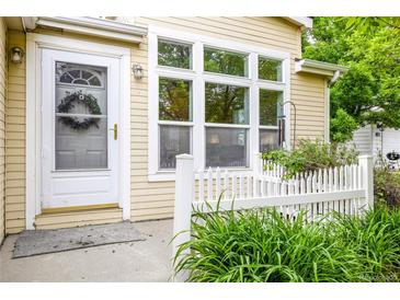 Charming home exterior featuring a white front door with a wreath and adjacent large window at 7725 Hummingbird Green # 78, Frederick, CO 80530