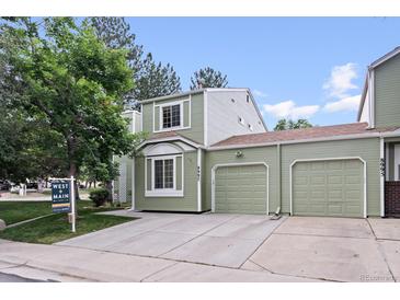 Charming two-story home with an attached two car garage, neutral exterior, and well-manicured lawn at 8997 W 88Th Ave, Westminster, CO 80021