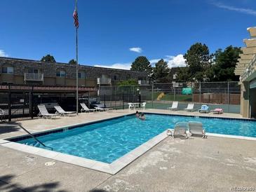 Community pool with lounge chairs, perfect for relaxation and recreation at 7455 E Quincy Ave # 204, Denver, CO 80237