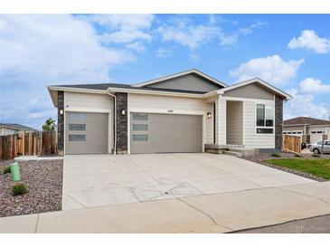 Charming single-Gathering home boasting a three-car garage, and modern architectural design with stone accents at 1592 Maggie Mae Ln, Castle Rock, CO 80104
