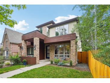 Contemporary home featuring stone accents, a covered entryway, and well-maintained landscaping at 1511 S Pennsylvania St, Denver, CO 80210