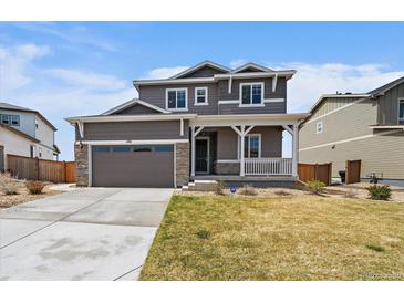Charming two-story home with a covered front porch and manicured lawn at 11741 Magnolia St, Thornton, CO 80233