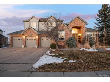 Two-story brick home with three-car garage and landscaped yard at 27319 E Nova Cir, Aurora, CO 80016