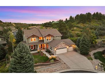 Two-story house with stone accents, a three-car garage, and a landscaped yard at 1402 Sterling Hill Ct, Castle Rock, CO 80104