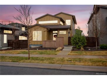 Beautiful two-story home showcasing an eye-catching facade with ample windows and a well-kept front yard at 9734 Bennett Peak St, Littleton, CO 80125