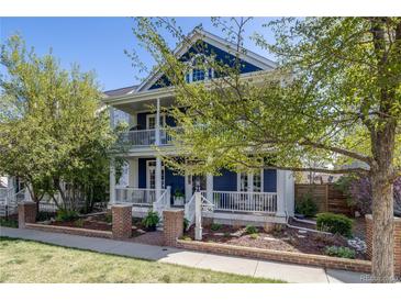 Charming two-story home featuring double porches and a beautifully landscaped front yard at 8156 E 35Th Ave, Denver, CO 80238