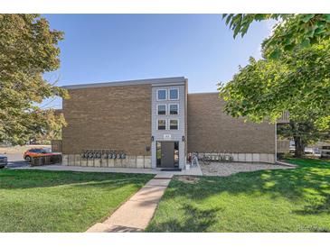 Brick building exterior with landscaping and parking at 1612 Cottonwood Dr # 2W, Louisville, CO 80027