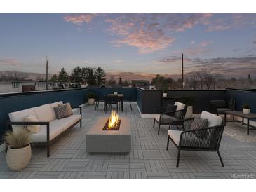 Inviting rooftop patio with modern seating, fire pit, and outdoor dining area, perfect for entertaining and enjoying city views at 535 Josephine St, Denver, CO 80206