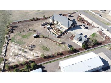 Expansive aerial view of a property featuring a large home, fenced yard, and outbuildings on a spacious lot at 15280 Bannock St, Broomfield, CO 80023
