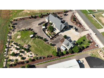 Expansive property with mature landscaping, featuring a custom home and multiple outbuildings at 15280 Bannock St, Broomfield, CO 80023