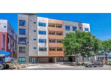 A modern apartment building with varied textures and colors offers covered parking and secure entry at 2729 W 28Th Ave # 401, Denver, CO 80211