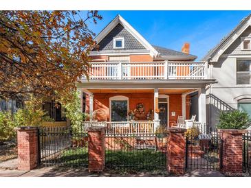Charming red brick two-story home with white trim, inviting porch, and beautiful architectural details at 1333 N Lafayette St, Denver, CO 80218