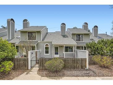 Charming townhome featuring a fenced front yard and unique architectural details at 494 Owl Dr # 4, Louisville, CO 80027