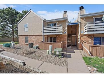 Charming townhome exterior with a cozy balcony and well-maintained landscaping at 3332 S Ammons St # 103, Lakewood, CO 80227