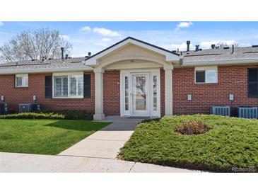 Charming brick home with a welcoming entrance and well-manicured lawn at 5425 County Road 32 # 14, Mead, CO 80504