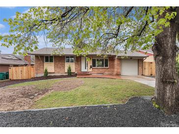 Charming brick home featuring a well-maintained lawn and inviting front entrance at 380 S Xanadu St, Aurora, CO 80012