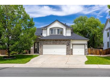Charming two-story home with a stone accent, three-car garage and well-manicured lawn at 3775 Balderas St, Brighton, CO 80601