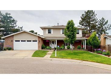 Charming two-story home with a well-manicured lawn and a two-car garage at 6278 E Euclid Ave, Centennial, CO 80111