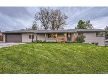 Charming single-story home with a well-manicured lawn and inviting curb appeal at 10698 W 26Th Ave, Lakewood, CO 80215