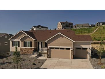 Beautiful, two-car garage home featuring stone accents, stylish curb appeal, and a well-maintained landscape at 4121 River Oaks St, Castle Rock, CO 80104