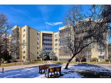A spacious condo building with well-maintained landscaping and visible blue skies at 13631 E Marina Dr # 608, Aurora, CO 80014