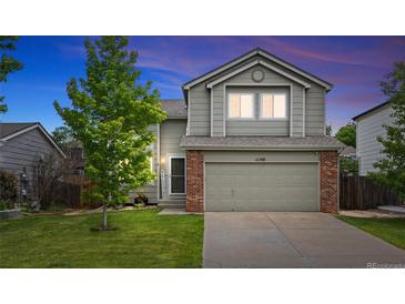 Charming two-story home with a well-maintained lawn and a two-car garage, perfect for Gathering living at 11188 Latigo Ln, Parker, CO 80138